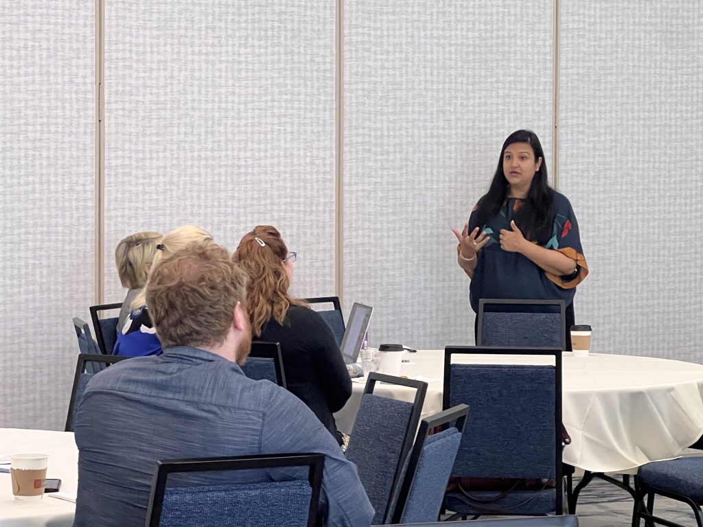 group of people sitting at tables at an event