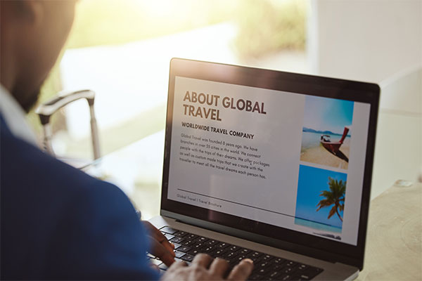 business man searching for global travel on a laptop