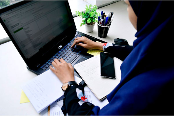 woman typing on a laptop