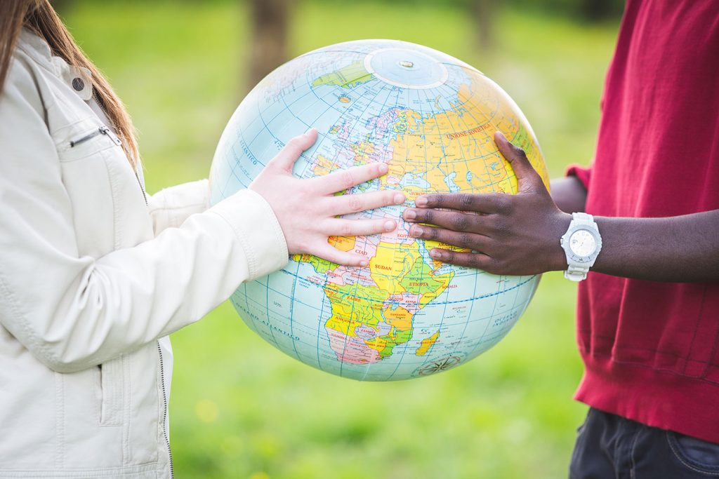 man and woman holding a globe