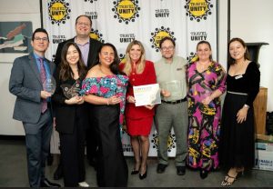 group of people holding awards and certificate