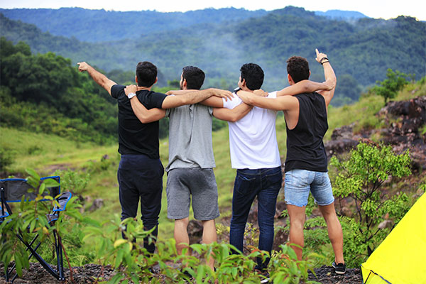 young men standing and hugging together