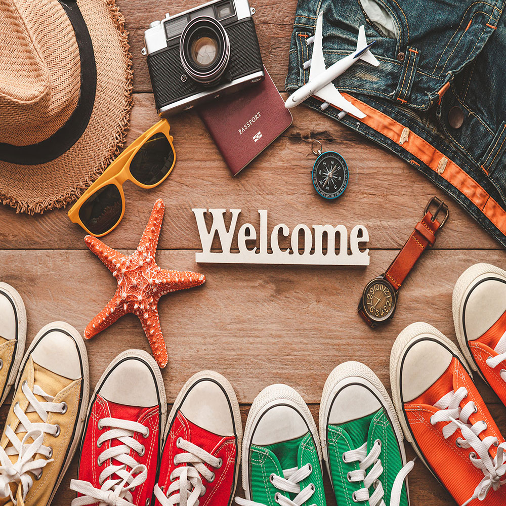colorful vacation travel accessories on wooden table