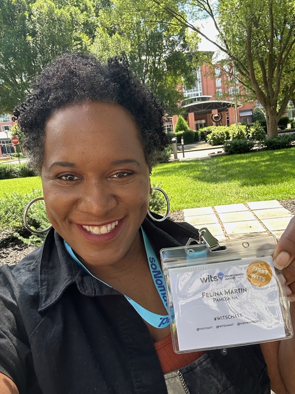 Felina Martin holding her WITS Chattanooga attendee badge.